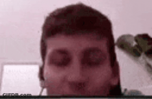 A Close Up Of A Man 'S Face With A Blurred Background . GIF
