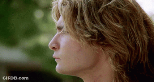 A Close Up Of A Man 'S Face With A Blurred Background GIF