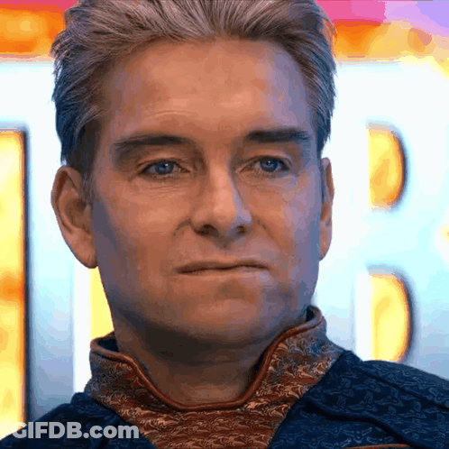 A Close Up Of A Man 'S Face With A Blurry Background GIF