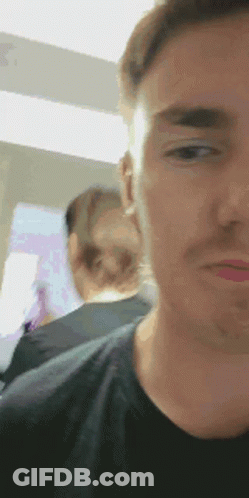 A Close Up Of A Man 'S Face With A Blurry Background GIF