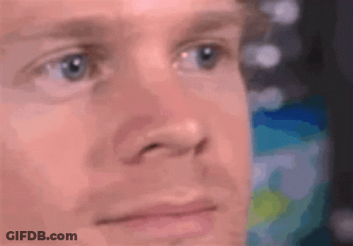 A Close Up Of A Man 'S Face With A Blurry Background . GIF
