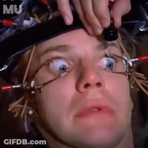 A Close Up Of A Man 'S Face With A Bottle In His Eye GIF