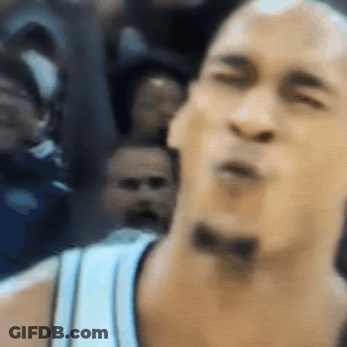 A Close Up Of A Man 'S Face With A Bow On His Neck GIF