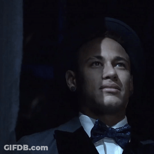 A Close Up Of A Man 'S Face With A Bow Tie And Earrings GIF