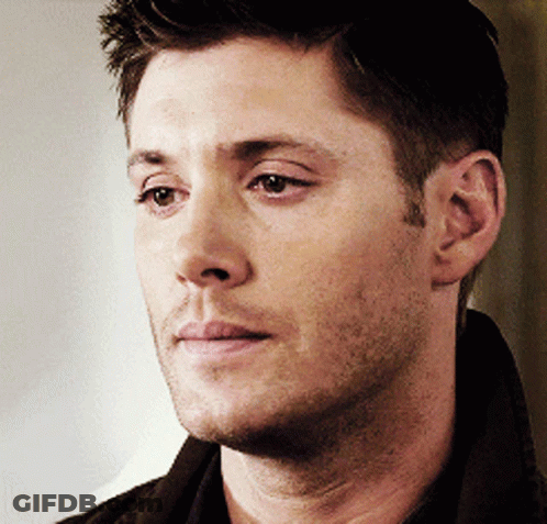A Close Up Of A Man 'S Face With A Brown Shirt On GIF
