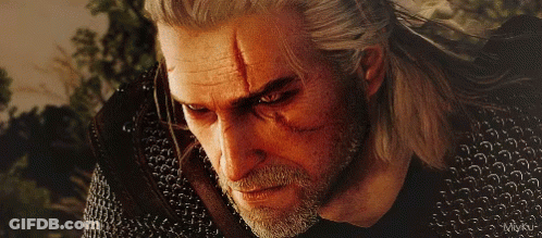 A Close Up Of A Man 'S Face With A Chain Mail Jacket GIF