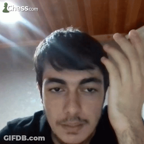 A Close Up Of A Man 'S Face With A Chess.com Logo In The Background GIF