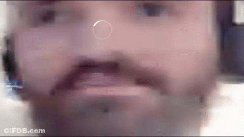 A Close Up Of A Man 'S Face With A Circle In The Middle Of His Nose . GIF