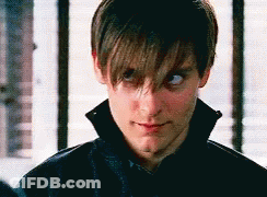 A Close Up Of A Man 'S Face With A Collar And A Black Jacket . GIF
