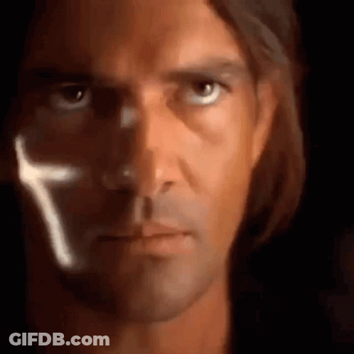 A Close Up Of A Man 'S Face With A Cross Coming Out Of His Eye . GIF