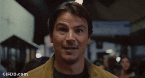 A Close Up Of A Man 'S Face With A Crowd In The Background GIF