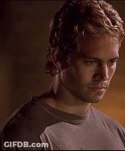 A Close Up Of A Man 'S Face With A Dark Background GIF