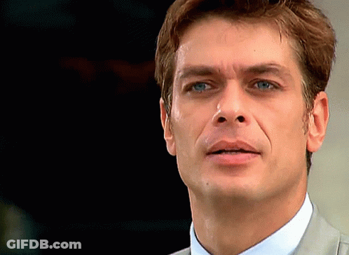 A Close Up Of A Man 'S Face With A Dark Background GIF