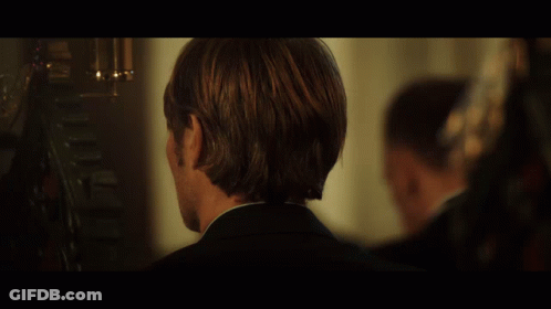 A Close Up Of A Man 'S Face With A Dark Background GIF