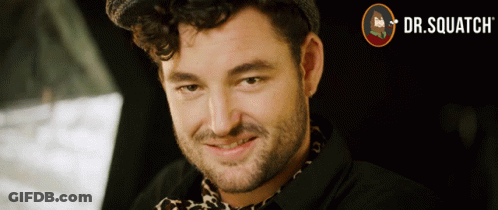 A Close Up Of A Man 'S Face With A Dr. Squatch Logo Behind Him GIF