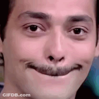 A Close Up Of A Man 'S Face With A Fake Mustache Making A Funny Face . GIF