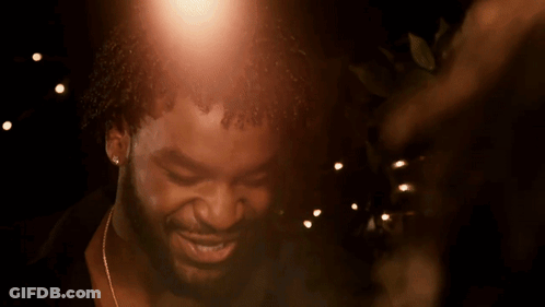 A Close Up Of A Man 'S Face With A Few Lights In The Background GIF