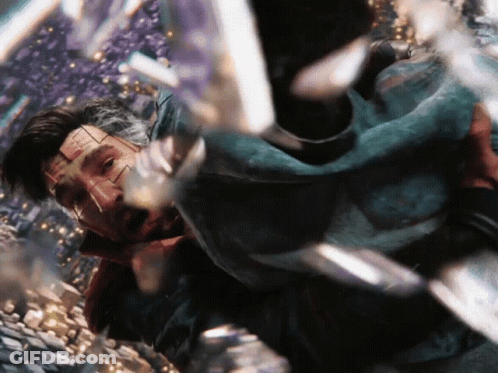A Close Up Of A Man 'S Face With A Few Pieces Of Glass Behind Him GIF