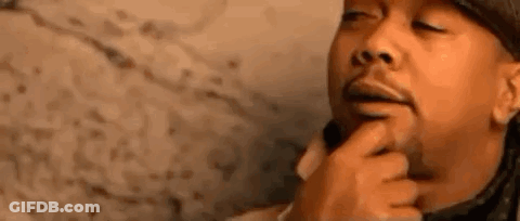 A Close Up Of A Man 'S Face With A Finger On His Chin . GIF