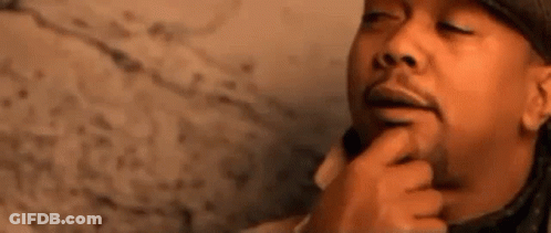 A Close Up Of A Man 'S Face With A Finger On His Chin . GIF