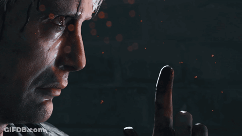 A Close Up Of A Man 'S Face With A Finger Pointing Up GIF