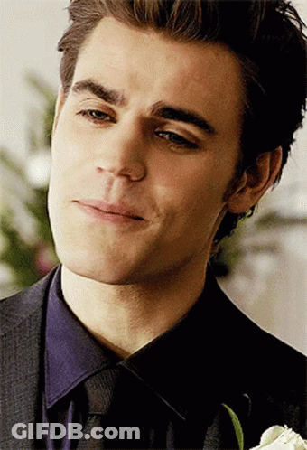 A Close Up Of A Man 'S Face With A Flower In The Foreground GIF