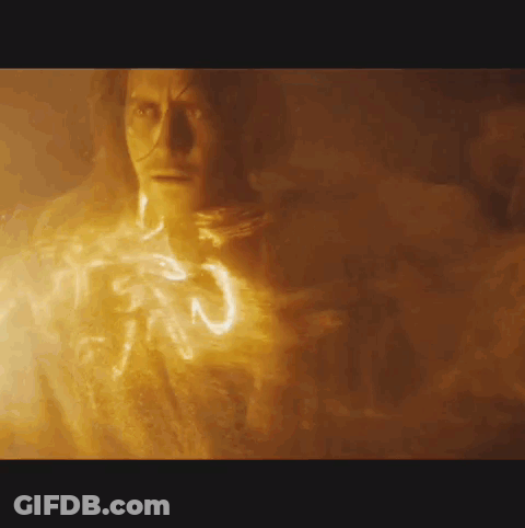 A Close Up Of A Man 'S Face With A Glowing Light Coming Out Of His Chest . GIF