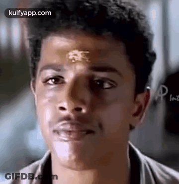 A Close Up Of A Man 'S Face With A Gold Sticker On His Forehead . GIF
