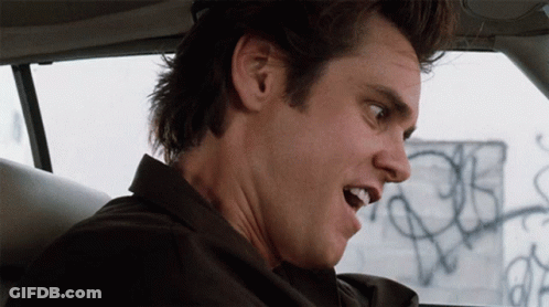 A Close Up Of A Man 'S Face With A Graffiti Wall In The Background GIF