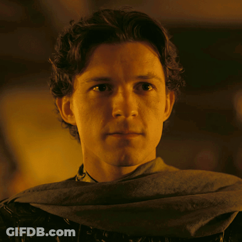 A Close Up Of A Man 'S Face With A Gray Scarf Around His Neck GIF