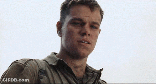 A Close Up Of A Man 'S Face With A Gray Shirt On GIF