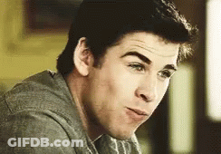 A Close Up Of A Man 'S Face With A Gray Shirt On Making A Funny Face . GIF