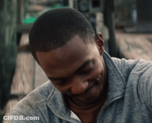 A Close Up Of A Man 'S Face With A Gray Sweatshirt On GIF