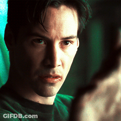 A Close Up Of A Man 'S Face With A Green Shirt GIF