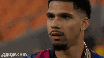 A Close Up Of A Man 'S Face With A Hand On His Face . GIF