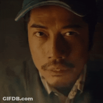 A Close Up Of A Man 'S Face With A Hat On And A Mustache . GIF