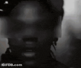 A Close Up Of A Man 'S Face With A Hat On . GIF