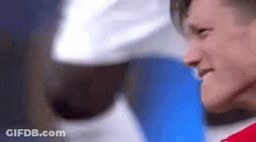 A Close Up Of A Man 'S Face With A Hat On . GIF