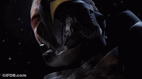 A Close Up Of A Man 'S Face With A Helmet And Gloves On GIF