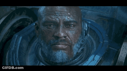 A Close Up Of A Man 'S Face With A Helmet On His Head GIF