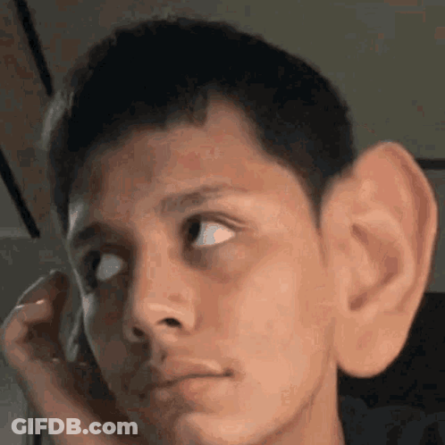 A Close Up Of A Man 'S Face With A Large Ear . GIF