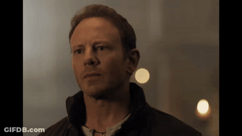 A Close Up Of A Man 'S Face With A Light Behind Him GIF