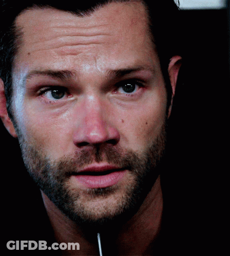A Close Up Of A Man 'S Face With A Lollipop Sticking Out Of His Mouth GIF
