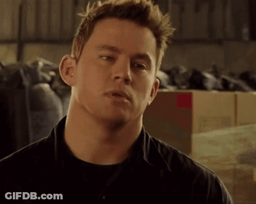 A Close Up Of A Man 'S Face With A Lot Of Boxes In The Background GIF