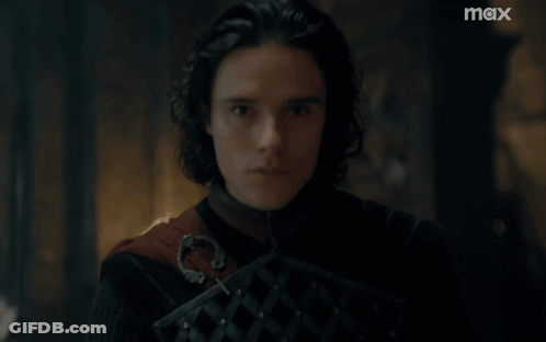 A Close Up Of A Man 'S Face With A Max Logo In The Background GIF