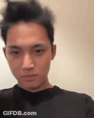 A Close Up Of A Man 'S Face With A Messy Hairdo . GIF