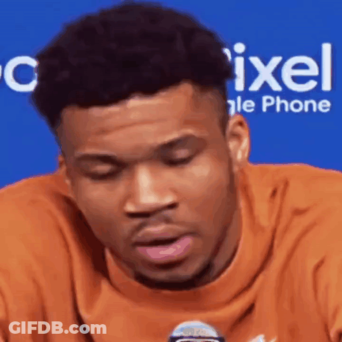 A Close Up Of A Man 'S Face With A Microphone In Front Of Him . GIF