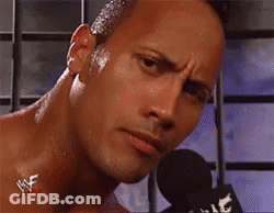 A Close Up Of A Man 'S Face With A Microphone In Front Of Him . GIF