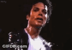 A Close Up Of A Man 'S Face With A Microphone In The Background . GIF