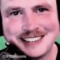 A Close Up Of A Man 'S Face With A Microphone On His Head . GIF